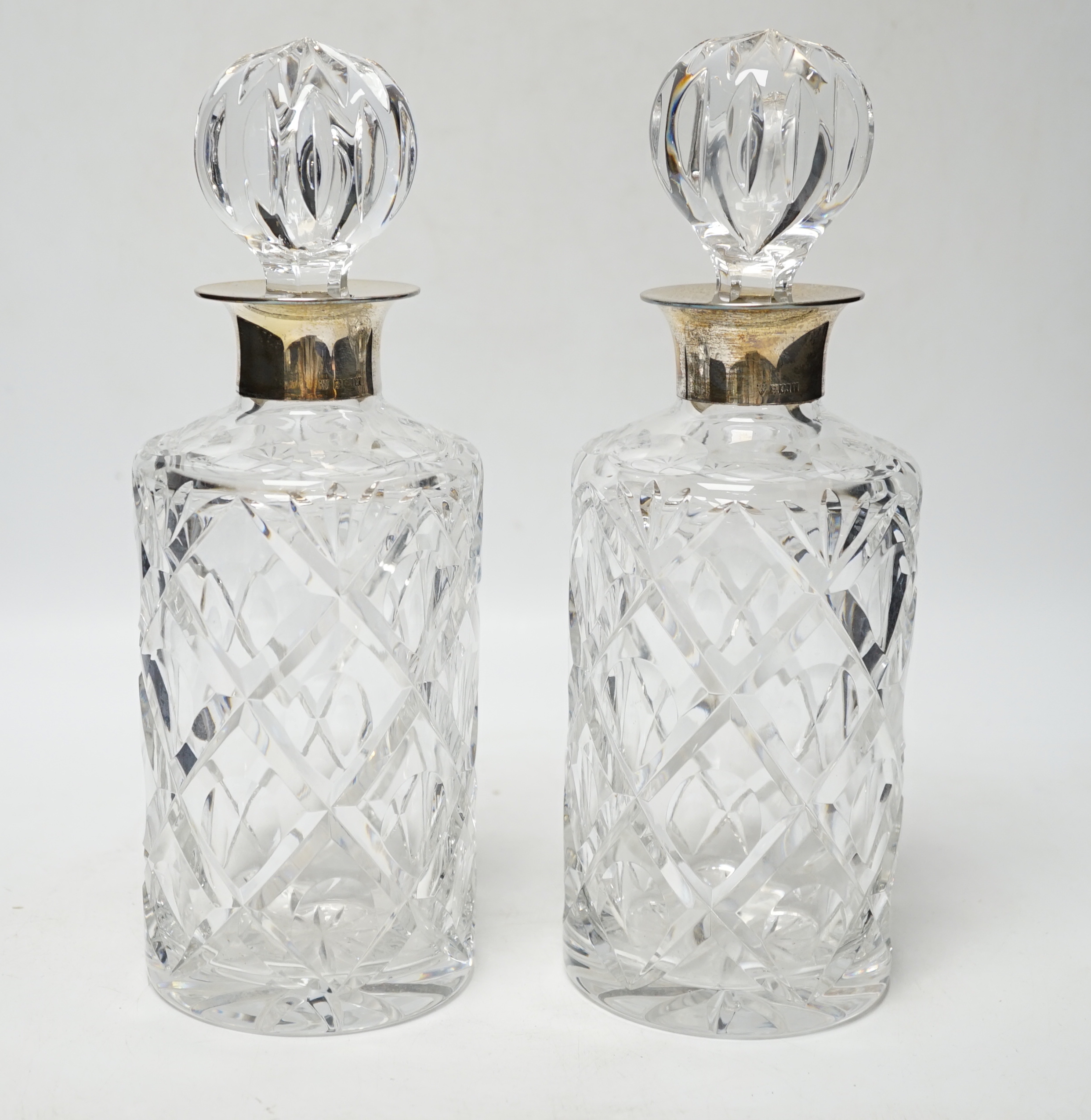 A modern pair of silver mounted cut glass cylindrical decanters with stoppers, Birmingham, 1971/73, 26cm.